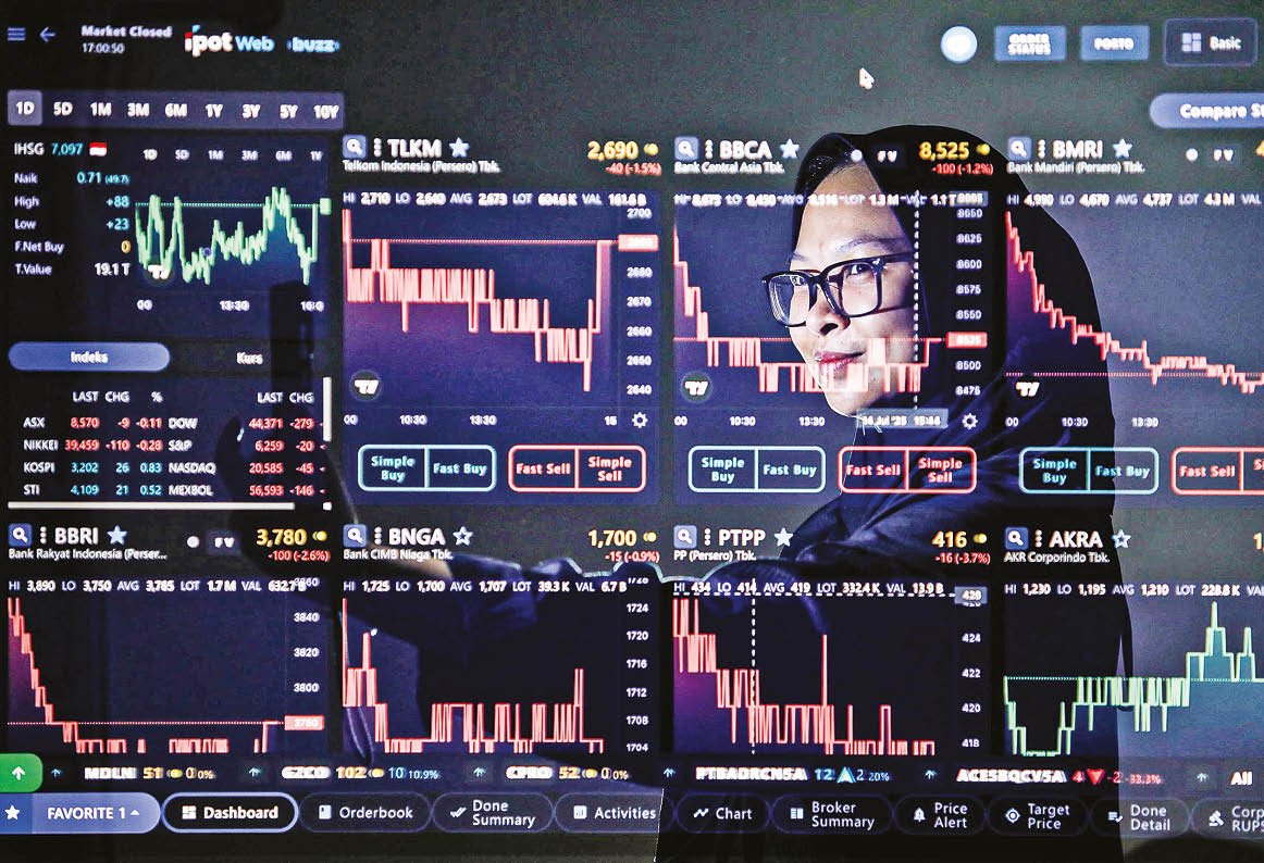 Bisnis/Himawan L Nugraha Investor mengamati layar pergerakan data saham di Jakarta.